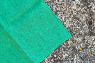 green linen table cloth on the grey stone  textured background