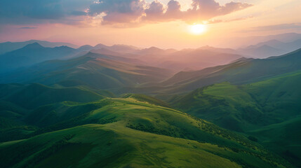 Aerial view of the green mountains and hills at sunset