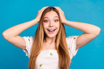 Photo of positive happy girl hands head look impressed isolated blue color background