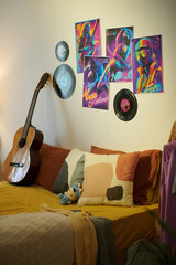 Music posters and vinyl records on wall in bedroom of teenager who dreams to be a musician