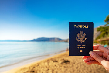 Man holding USA passport against the backdrop of a tropical country.