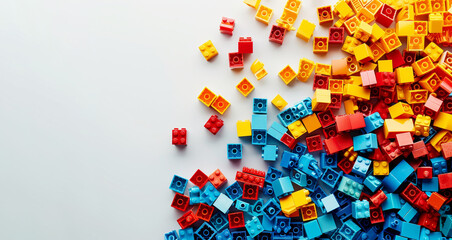 Colorful assorted building blocks scattered on white background