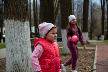 Girls playing outdoors with a ball in a park