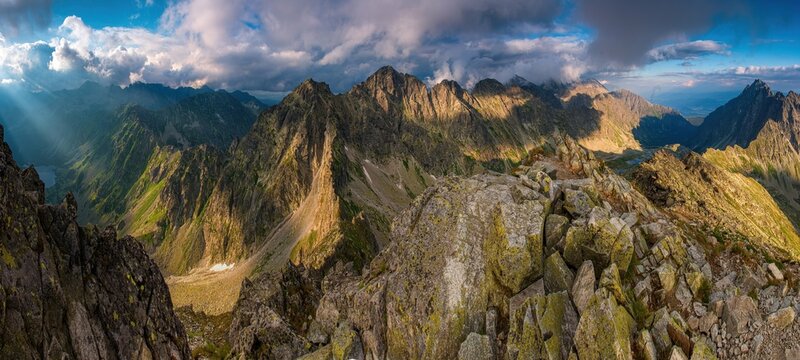 View from Koprovsky Stit, High Tatras, Slovakia. Velke Hincovo pleso and peak and summit of mountains. Sunny summer sunset. Beautiful rocky landscape. Very wide angle with distorted horizon.