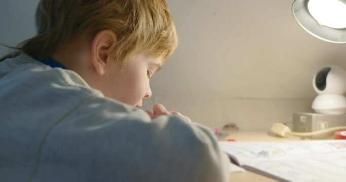 Kid Boy Study at Home. Schoolboy Doing Homework Sitting at Desk Table. 4K 10-bit