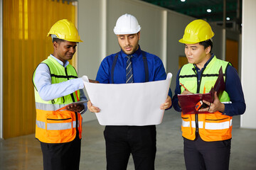 workers or engineers planning from work on blueprint drawing paper in the factory