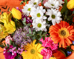 A vibrant bouquet with rich tapestry of floral hues, this arrangement mixes yellow tulips, white...