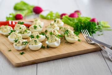 stuffed eggs, deviled eggs on a wooden table