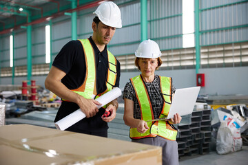 workers or engineers working on laptop computer in the factory