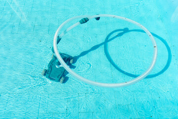 Water robot vacuum cleaner cleans, removes debris on the bottom, walls of the pool, top view...