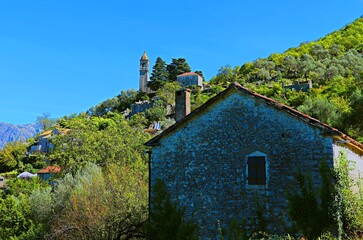 An ancient Orthodox church on the top of a mountain, a mountain settlement, residential stone...
