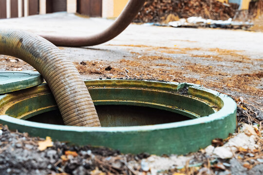 Pipe in the drainage pit. Pumping out sewage from a septic tank. Septic tank service