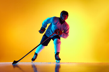 Hockey player maneuvers his stick with unwavering concentration, each motion testament to...