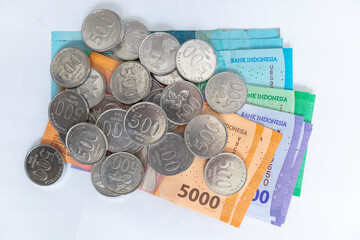 Top view of Indonesian Rupiah money and coins on a white background. Rupiah banknotes.