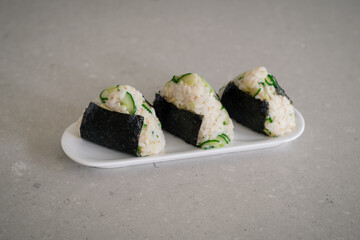 Homemade Onigiri Kyuri, rice triangle with cucumber, sesame seeds, ginger, nori seaweed