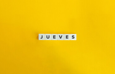 Word JUEVES. Thursday in Spanish. Text on Block Letter Tiles on Flat Background. Minimalist Aesthetics.