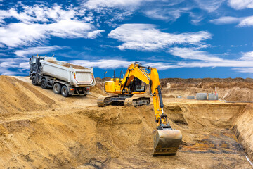 excavator is working and digging at construction site - 792934685