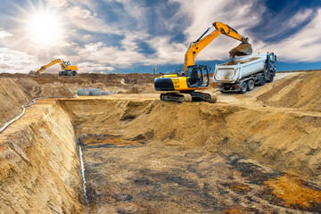 excavator is working and digging at construction site - 792934877