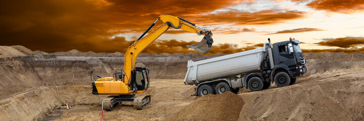 excavator is working and digging at construction site - 792935088