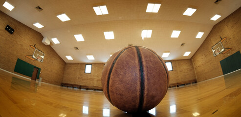 Basketball on Court with Hoops Rim Hardwood Floor Lights