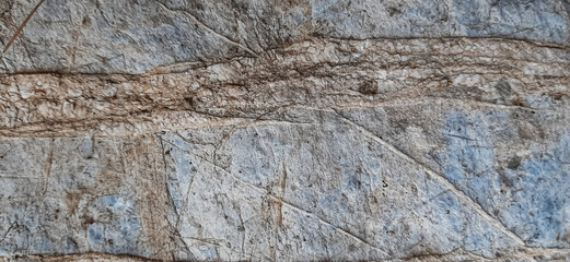 Rock, stone, textured. Stone wall background with space for design. Cracked rough mountain surface