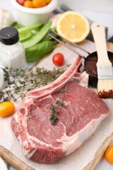 Raw meat, thyme and marinade on table, closeup