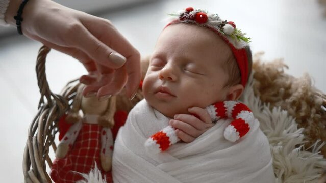 Solicitous Mother Softly Stroking Her Cute Sleeping Newborn Baby Girl Wearing To Christmas Holidays