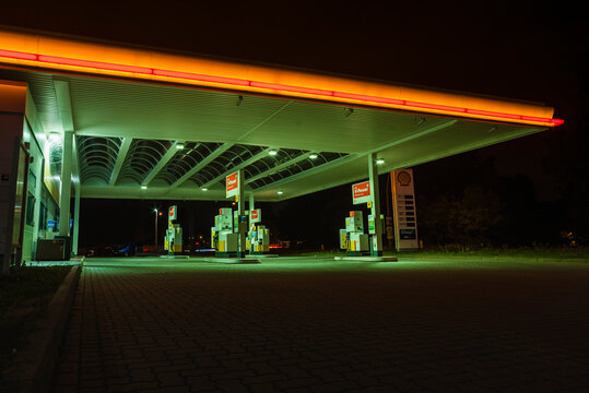 a shell gas station at night, no cars, empty, lit up