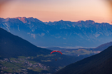 Sunset Paragliding Over Stubai Valley - obrazy, fototapety, plakaty
