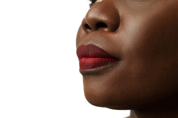 Cropped image of African woman's face, nose, lips isolated on white studio background. Face...