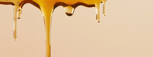 Drops of honey on a beige background
