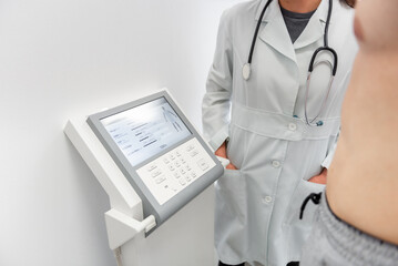 Health checkup in progress, a medical professional operates advanced diagnostic equipment