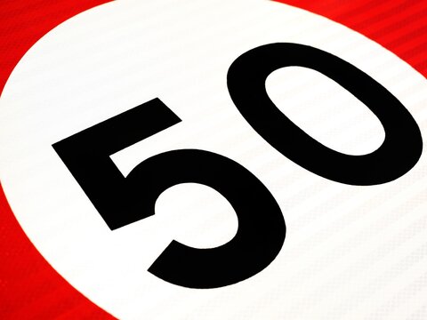 Close-up of a 50 km/h speed limit road sign