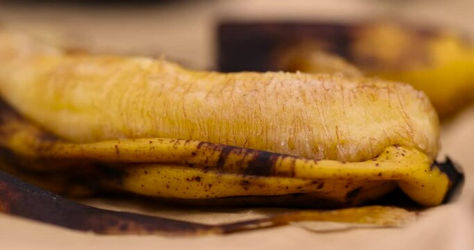An old dark banana in close-up, an overripe dark banana that is spoiling