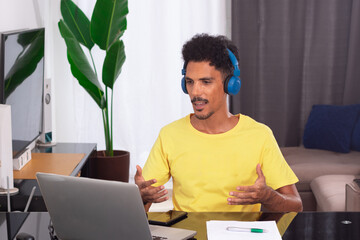 Black Man Wearing Yellow T-shirt at Remote Job. Young Digital Nomad on a Teleworking Meeting