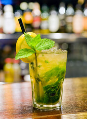 mojito cocktail with rum and lemon on bar counter