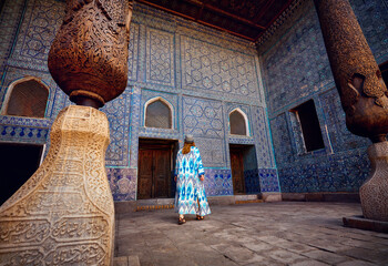Woman tourist at old city Khiva in Uzbekistan