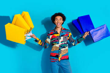 Photo portrait of handsome young guy hold shopping bags dressed stylish print garment isolated on...