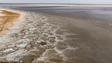 cosmic unreal landscapes of the Baskunchak salt lake on a spring day from the height of a drone...