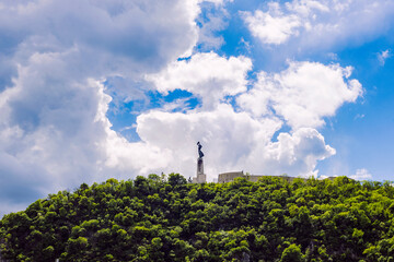 View of Hungarian Statue of Liberty against blue sky with beautiful white clouds, Budapest, Hungary