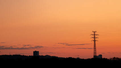 Silhouette of the city against the background of a pink summer sunset
