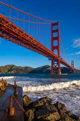 Wide angle view of iconic Golden Gate Bridge from ”Fort Point“ on a windy, sunny spring...