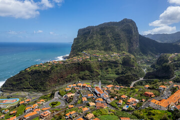 Madeira Island landscape, small village on hills and green lush forest. Aerial drone view. Portugal travel.