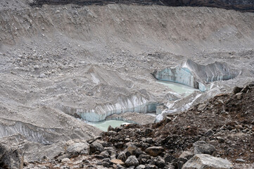 View of Khumbu glacier nearly Everest base camp covered by moraine rocks. - obrazy, fototapety, plakaty