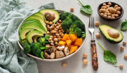 healthy vegan lunch bowl with Avocado, muShroomS, broccoli, spinach, chickpeas