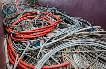 discarded electrical cords at the electrical cord scrapyard for recycling copper and polluting...