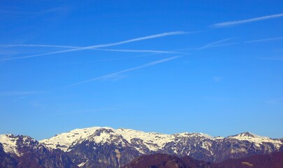 mountain panorama with white chemtrails left by the Arians or by something else According to the...