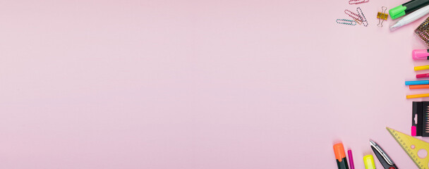 Back to school. Stationery on a pink table. Office desk with copy space. Flat lay. Banner.