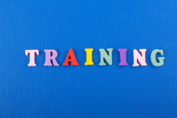TRAINING word on blue background composed from colorful abc alphabet block wooden letters, copy...
