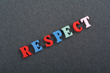 RESPECT word on black board background composed from colorful abc alphabet block wooden letters, copy space for ad text. Learning english concept.